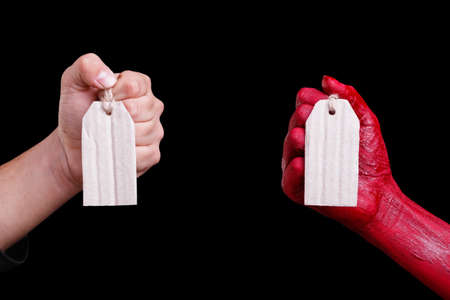 Human hands painted in red are posing on a black background.の写真素材