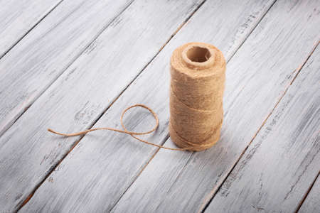 Top view on a ball of threads on the wooden background.の写真素材