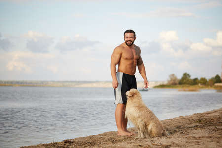 Happy labrador enjoy playing on beach with owner.の写真素材