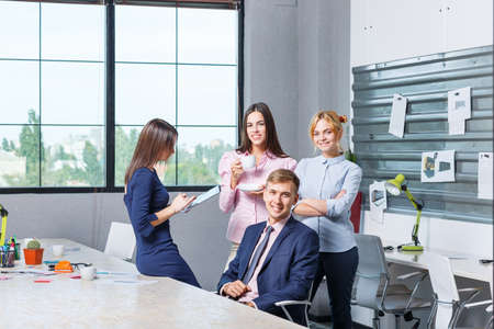 Team of business, friendly office workers in a working office premiseの写真素材