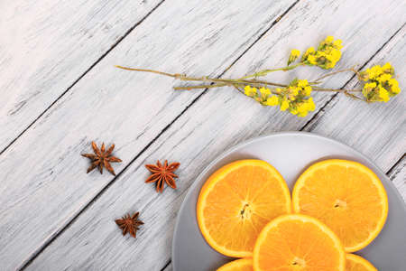 Composition with oranges and flowers on the tableの写真素材