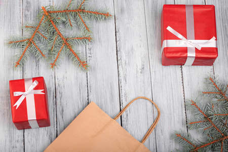 Two gifts in red with white bows. On a gray wooden background.の写真素材