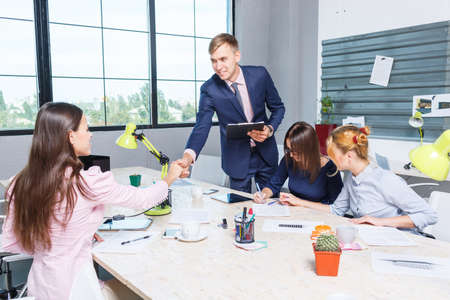 The chief shakes the girls hand to the employeeの写真素材