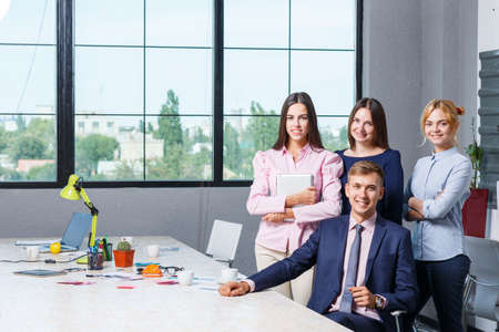 Team of business, friendly office workers in a working office premiseの写真素材