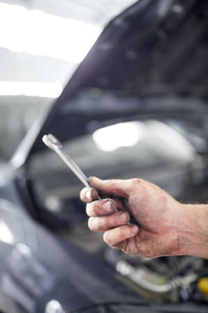 Mehaynik repairs parts under the hood. Repair and maintenance of cars.