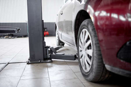 Lifted cars on the lift in a car service for diagnosisの写真素材