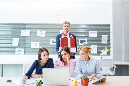 Business team in a modern bright office interior at work on a laptop.の写真素材