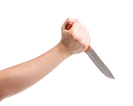 A man's hand holding a sharp knife firmly. On an isolated white background. Close-up.の写真素材