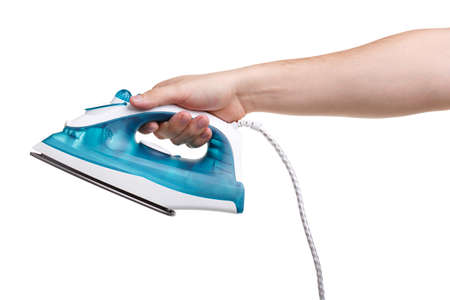 Hand of a man who holds a blue iron on a white background isolated. Close-up. Conception - electronics.の写真素材