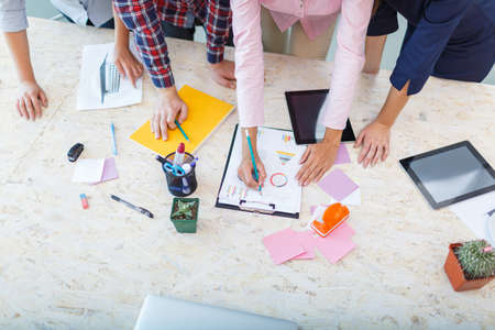 Business meeting. Close-up of young people who share something.の写真素材