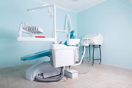 Workplace of the dentist on a blue background of the office, a blue chair for the patientの写真素材