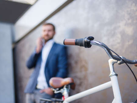 Businessman with a business conversation, a bicycle nearの写真素材