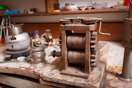 Close-up picture of different crafting tools on a workshop table background. Handmade classic craft jewelry making on vintage equipment.の写真素材