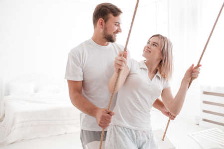 Sensual young couple together in bedroom. Happy couple in love isolated on a white background.の写真素材