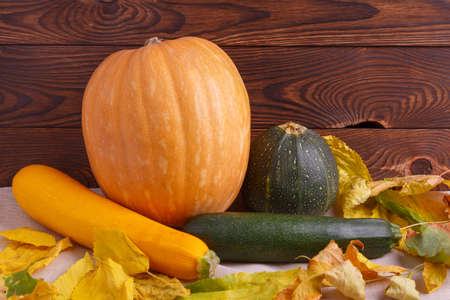 Autumn concept of vegetables on a brown wooden backgroundの写真素材