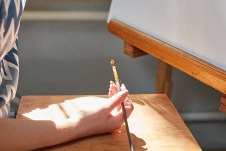Humans hand golding a brush for painted in a work room. Art concept.の写真素材