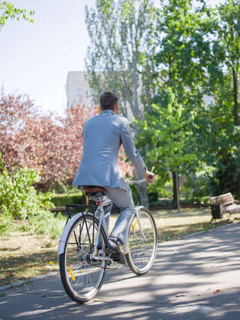 The guy in a beautiful suit leaves forward along the roadの写真素材