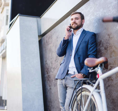 Businessman with a business conversation, a bicycle nearの写真素材