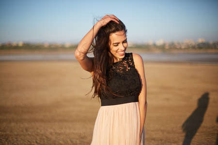 Relaxed beautiful girl on a natural background. Woman in a dress. Elegance concept. Copy space.の写真素材