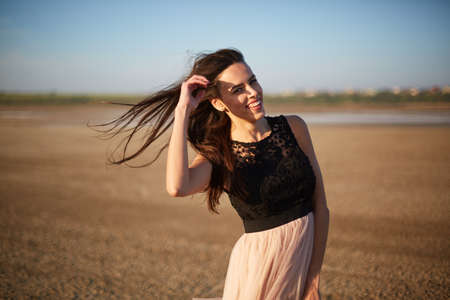 Relaxed beautiful girl on a natural background. Woman in a dress. Elegance concept. Copy space.の写真素材