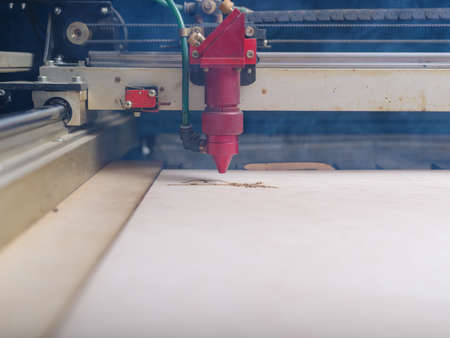 Automated machine for burning out patterns on a tree cut a leaf of a treeの写真素材