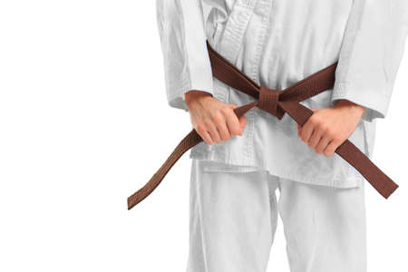 Man in kimono and belt for martial arts on isolated white background. Close-up. The concept of sport.の写真素材