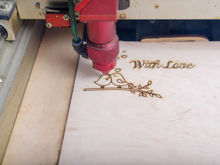Automated machine for the burning of patterns on the tree began its work on patterns and...