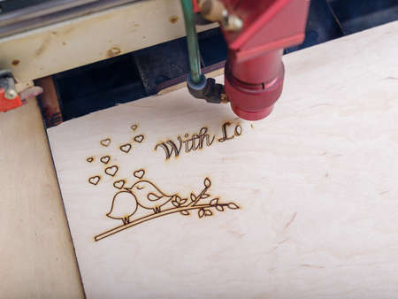 Automated machine for the burning of patterns on the tree began its work on patterns and...