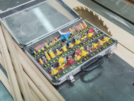 A set of different yellow tips for drilling or hammering holes in a box against the background of a...