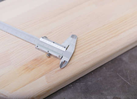 Calipers close-up on a wooden table in the masters workshop