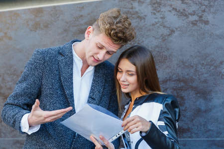 Young girl and man are looking at documents.の写真素材