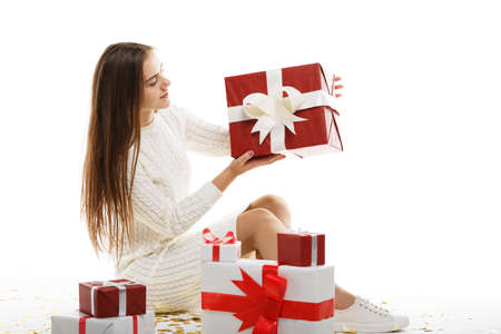 Young girl with gifts isolated on white background.