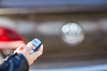 Hand a girl with a remote control from her carの写真素材