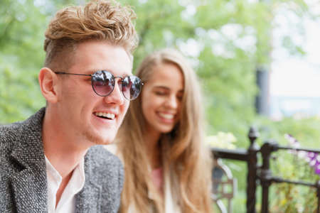 Happy boyfriend and girlfriend at the cafe on a blurred background. Relationship concept. Copy...