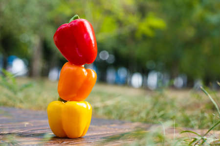 Bulgarian pepper on a brown wooden background with a blurred backgroundの写真素材
