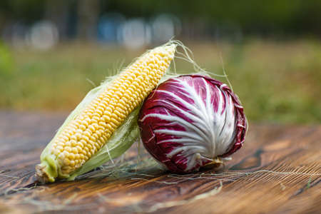 Violet cabbage on a brown wooden background closeupの写真素材