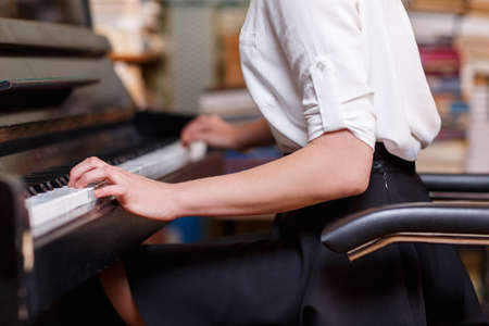 Close-up of the hand of a woman who plays the piano.の写真素材