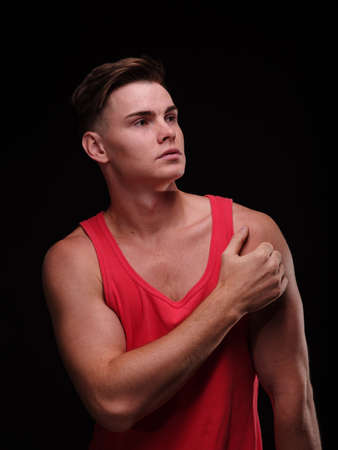 Handsome guy on a black background. Passionate muscular man posing. Young male beauty concept.の写真素材