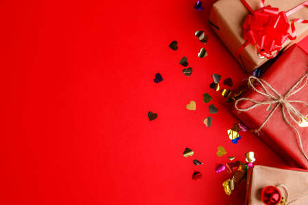 Gifts close-up with sparkles on a red table backgroundの写真素材