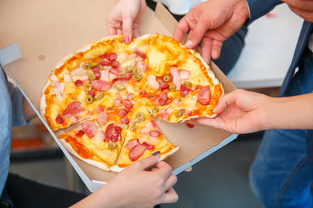 The ordered pizza in a close-up box is very appetizingの写真素材