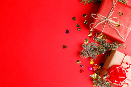 Gifts close-up with sparkles on a red table backgroundの写真素材