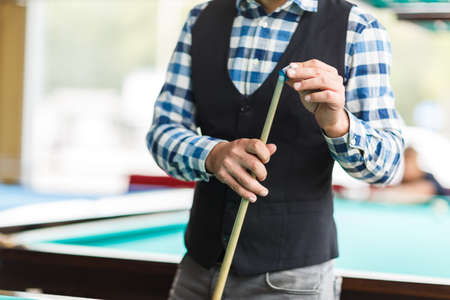 The player rubs the cue with special chalk