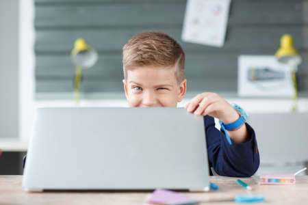 A small businessman opens a laptop in his place