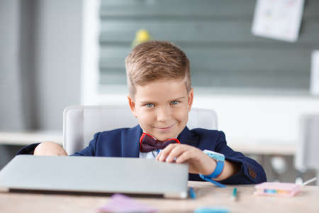 A small businessman opens a laptop in his place