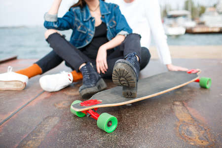 Cheerful young couple having fun and laughing together outdoors.の写真素材