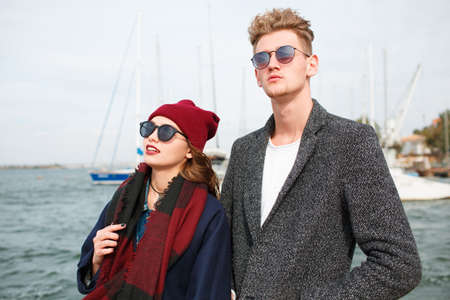 Cheerful young couple having fun and laughing together outdoors.の写真素材