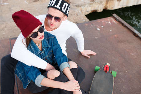 Cheerful young couple having fun and laughing together outdoors.