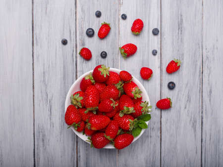 Fresh ripe fruits on a gray wooden table. Sweety red strawberries summer fruits on a gray background. Close-up of strawberry. Food concept.の写真素材