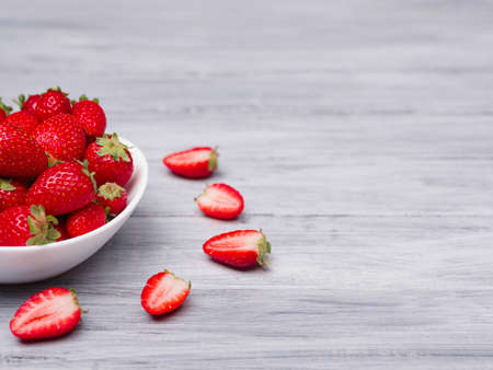 Fresh ripe fruits on a gray wooden table. Sweety red strawberries summer fruits on a gray background. Copy space. Close-up of strawberry. Food concept.の写真素材