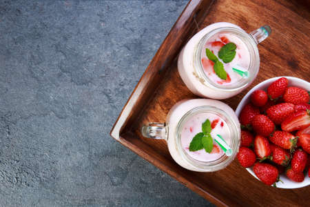 Sweet fresh strawberries in bowl on a wooden tray. Food concept.の写真素材